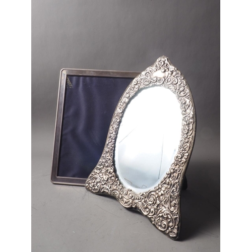 257 - A silver framed easel mirror with scrolled decoration and bevelled plate, 12 1/2