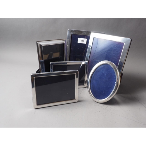 258 - Five modern silver rectangular photograph frames and a similar oval photograph frame