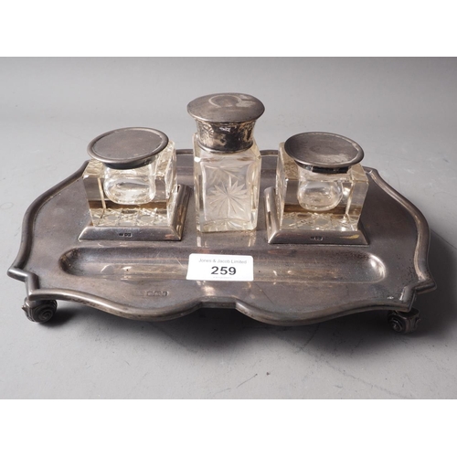 259 - A silver desk inkstand with two cut glass inkwells, and a silver mounted toilet jar, 20oz troy appro... 