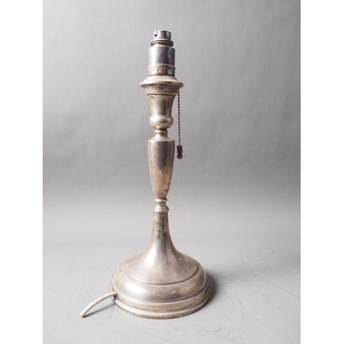 260 - A filled silver table lamp, on circular stepped base, 14 1/2