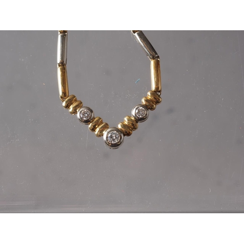 284 - An 18ct two colour gold and diamond necklace, 21.2g