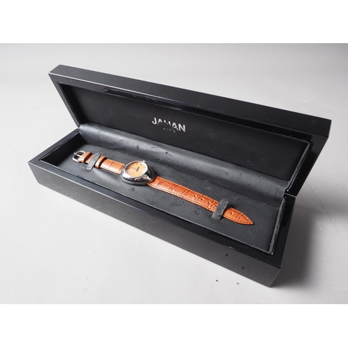 306 - A Jahan Geneve stainless steel cased wristwatch with orange dial and baton numerals, on brown crocod... 