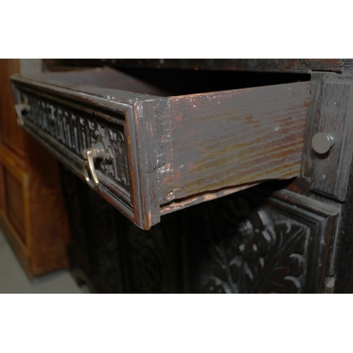 410 - A 19th century carved oak fall front bureau, the interior fitted drawers and pigeonholes, over two d... 