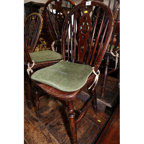 422 - A pair of 19th century Windsor star and spindle back dining chairs with elm panel seats, on turned a... 