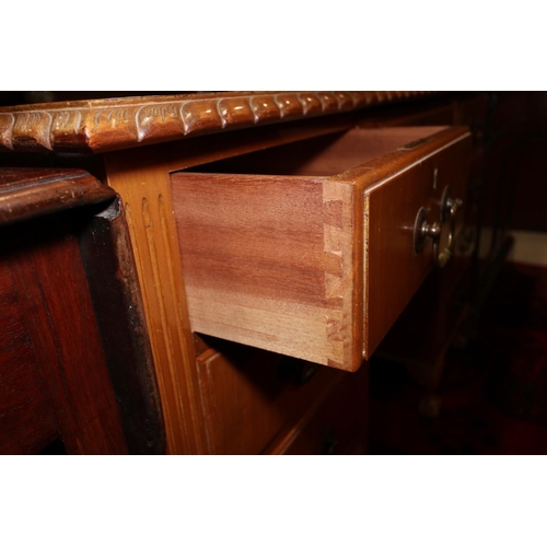 483 - A mid 20th century carved walnut double pedestal desk with tooled lined top over nine drawers, on ca... 