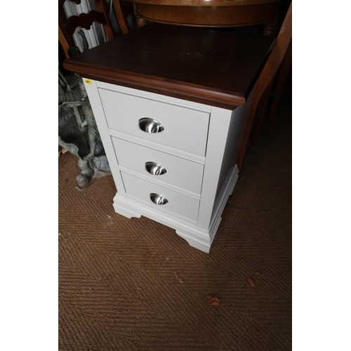 556 - A light grey and walnut top bedside cupboard, fitted three drawers, 18