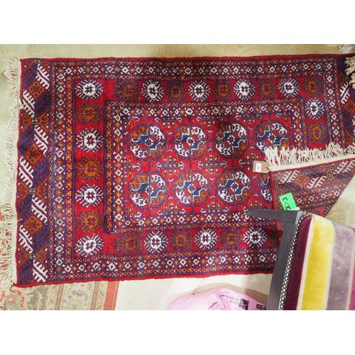 586 - A Bokhara rug of traditional design in shades of red, blue, rust and natural, 61