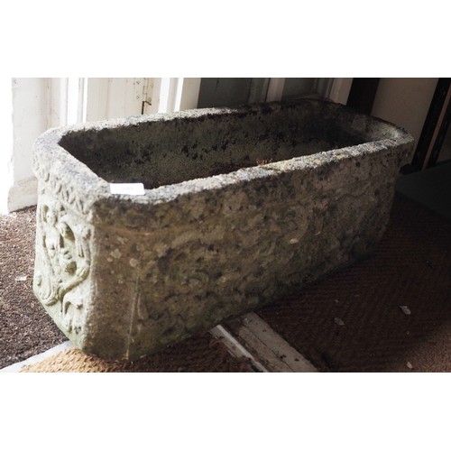 591 - A cast stone garden planter with relief decorated sides, 27