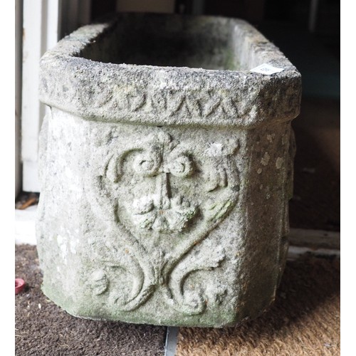 591 - A cast stone garden planter with relief decorated sides, 27