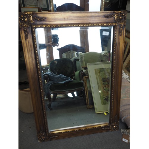 453 - A rectangular ornate gilt framed wall mirror with bevelled plate, 19 1/2