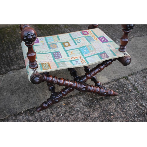 447 - A 19th century heavily turned oak folding chair with seat and back panels in a later tapestry