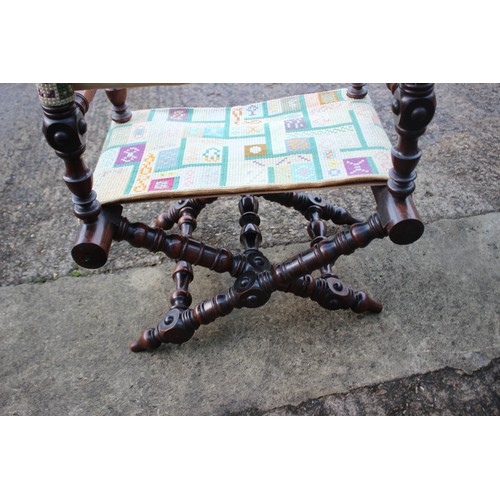 447 - A 19th century heavily turned oak folding chair with seat and back panels in a later tapestry