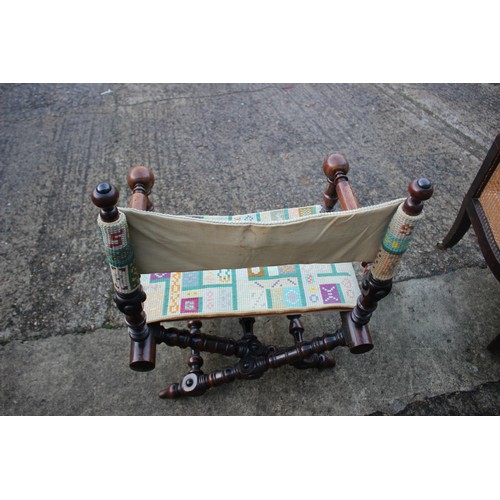 447 - A 19th century heavily turned oak folding chair with seat and back panels in a later tapestry