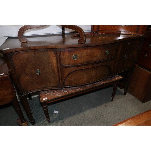 543 - A mahogany serpentine sideboard, fitted two side cupboards and two central drawers, on square tapere... 