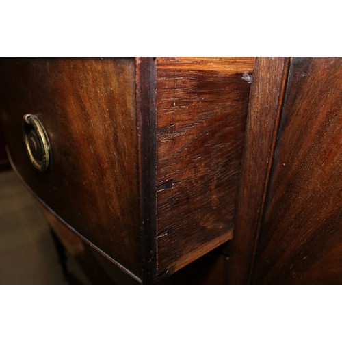 543 - A mahogany serpentine sideboard, fitted two side cupboards and two central drawers, on square tapere... 