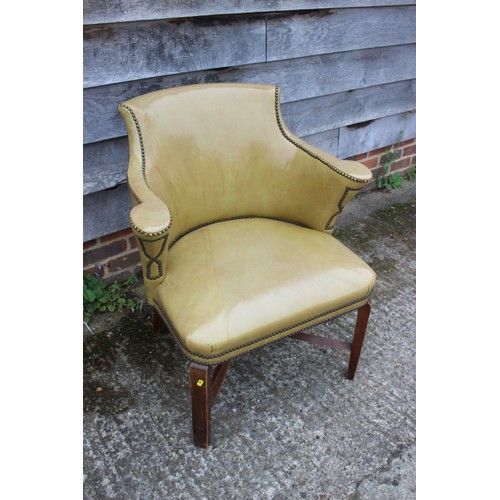 490 - A studded armchair, upholstered in a mustard leather, on stained as walnut cross stretchered support... 