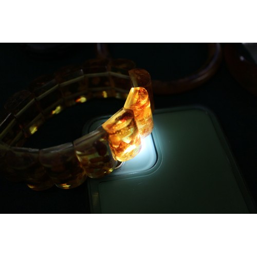 292 - A collection of amber Bakelite bangles and bracelets, 280.4g gross