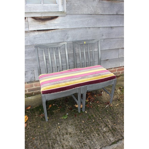 473 - A two-seat chair back settee, upholstered in a gold, deep crimson and brown fabric, 37