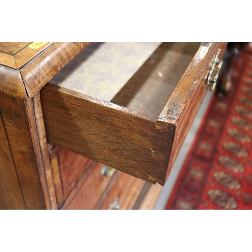 443 - An early 18th century figured walnut and banded chest on stand, the upper section fitted two small d... 