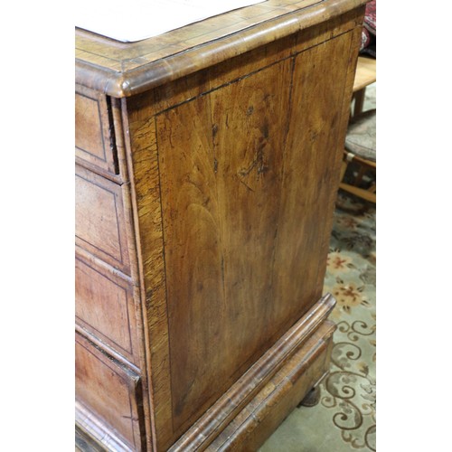 443 - An early 18th century figured walnut and banded chest on stand, the upper section fitted two small d... 