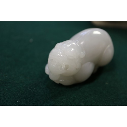 67 - A Chinese carved pale jade model of a mythical beast, 2 3/4