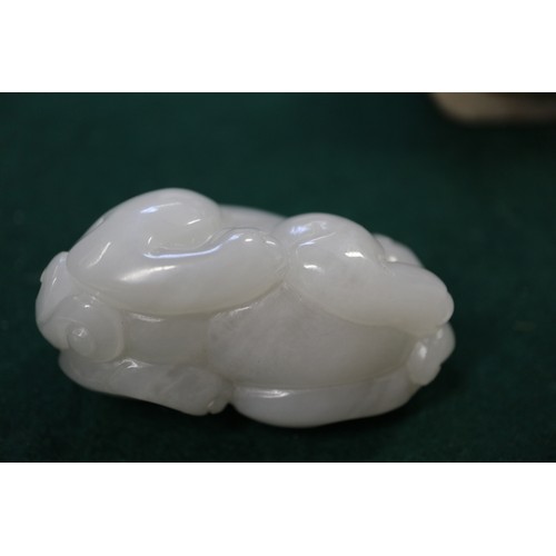 67 - A Chinese carved pale jade model of a mythical beast, 2 3/4