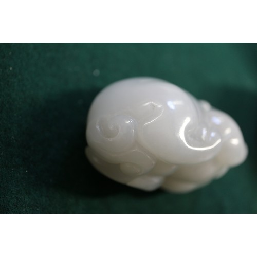 67 - A Chinese carved pale jade model of a mythical beast, 2 3/4