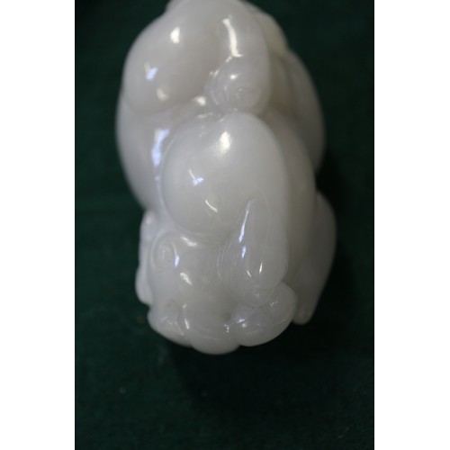 67 - A Chinese carved pale jade model of a mythical beast, 2 3/4