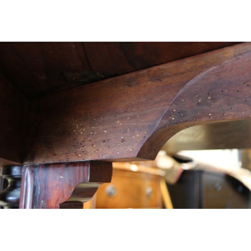 425 - A 19th century rosewood oval drop leaf table, on folding quadruple scroll supports, 36