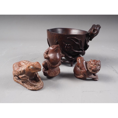 85 - A Chinese hardwood libation cup with relief carved tree, leaf and flower decoration, 3 1/4