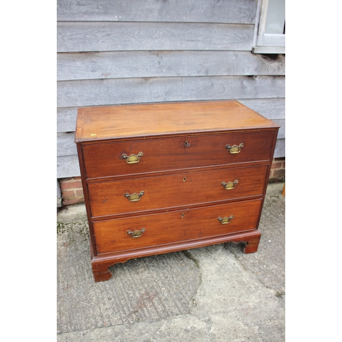 252 - A Georgian mahogany and inlaid chest of three long graduated drawers, on bracket supports, 41