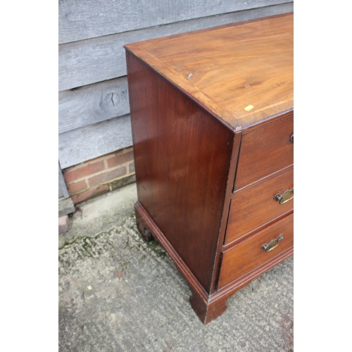 252 - A Georgian mahogany and inlaid chest of three long graduated drawers, on bracket supports, 41