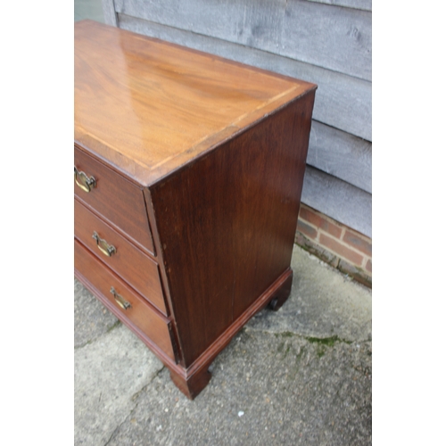 252 - A Georgian mahogany and inlaid chest of three long graduated drawers, on bracket supports, 41