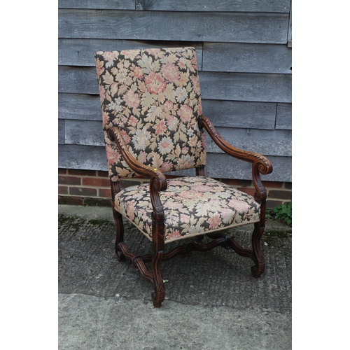 269 - A carved walnut open armchair of 17th century design, upholstered in a floral tapestry, on shaped st... 