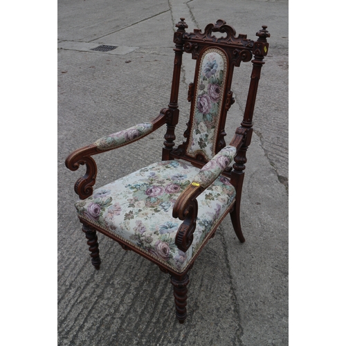 282 - A carved oak armchair with floral upholstered back and seat, on barley twist supports