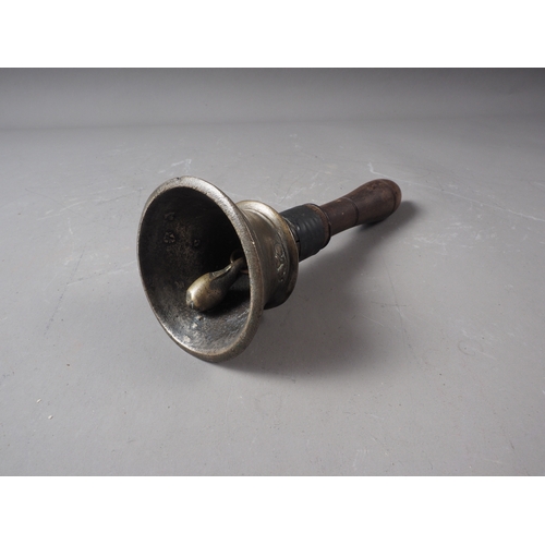 104 - An early 19th century Indian bell metal hand bell with turned hardwood handle, 7 1/2