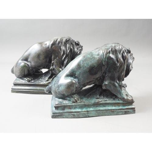 106 - A pair of patinated brass lion doorstops with wild boar, 8