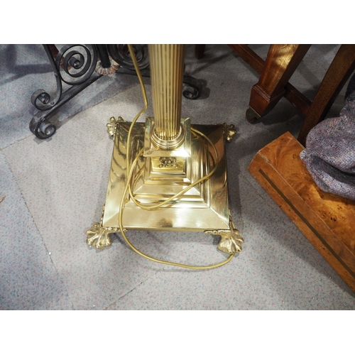 161 - An Edwardian brass adjustable standard lamp with reeded column and square base with ball and claw su... 