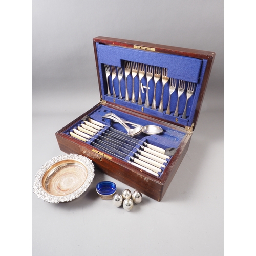 170 - A silver plated part table canteen, in mahogany case, a 19th century Sheffield plate bottle coaster ... 