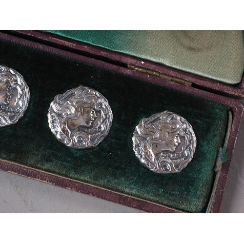 173 - A set of six silver Art Nouveau embossed silver buttons, woman's head design, in case