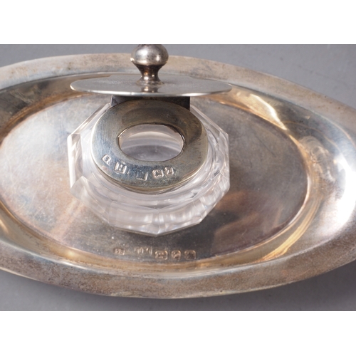 184 - An oval silver desk stand with cut glass inkwell, 1.9oz troy approx