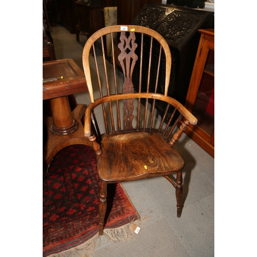 255 - An ash and elm Windsor armchair with panel seat and crinoline stretcher