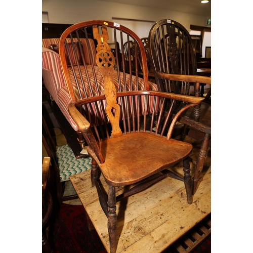 256 - An ash and elm Windsor armchair with panel seat and crinoline stretcher