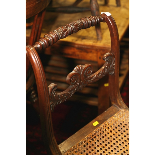 266 - A pair of early 19th century carved mahogany bar back side chairs with cane seats, on sabre leg supp... 