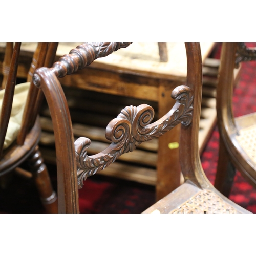 266 - A pair of early 19th century carved mahogany bar back side chairs with cane seats, on sabre leg supp... 