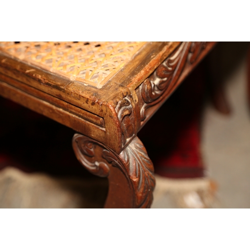 266 - A pair of early 19th century carved mahogany bar back side chairs with cane seats, on sabre leg supp... 