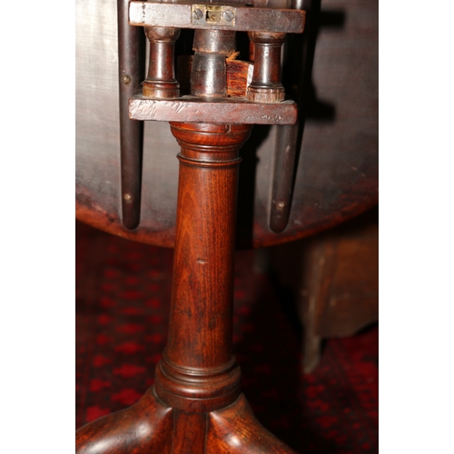 273 - A Georgian mahogany circular tilt top centre table with bird cage, on canon barrel turned column and... 