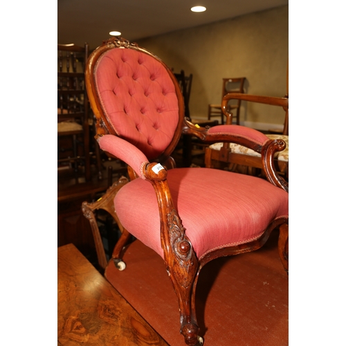 276 - A Victorian carved mahogany showframe spoon back chair, upholstered in a crimson fabric, on carved c... 