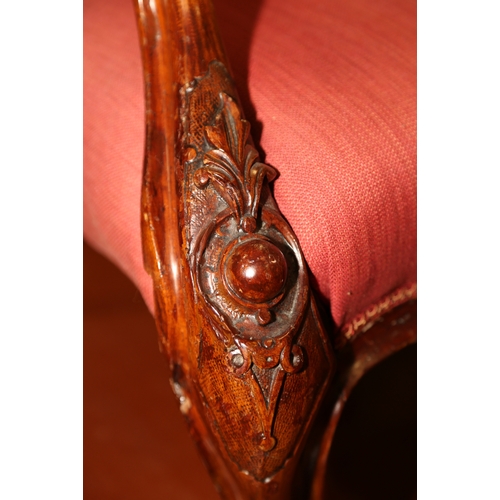 276 - A Victorian carved mahogany showframe spoon back chair, upholstered in a crimson fabric, on carved c... 