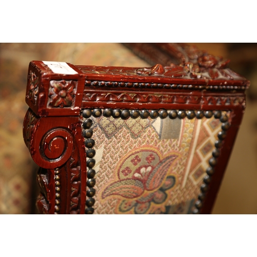 277 - A French carved and painted open armchair, upholstered in a patterned fabric, on turned and carved s... 